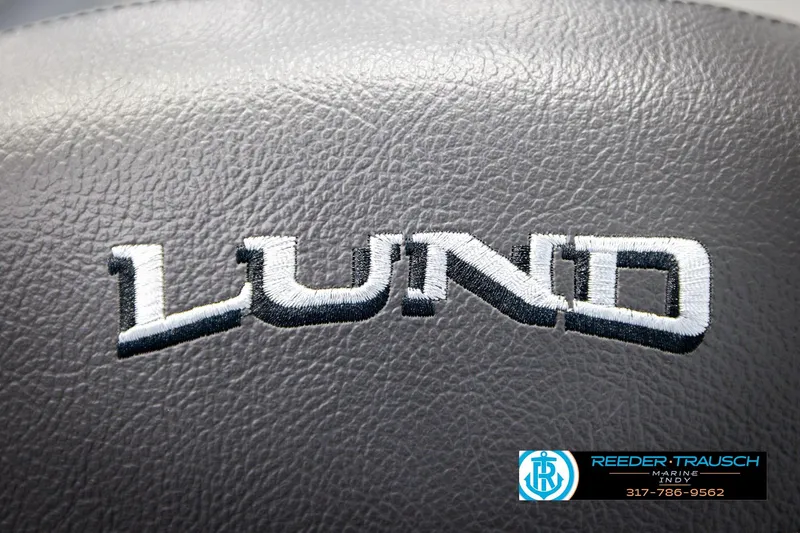 Slide: The Image of Lund 1600 Fury Tiller 2026 logo on textured surface, Reeder-Trausch Marine contact details. - 28