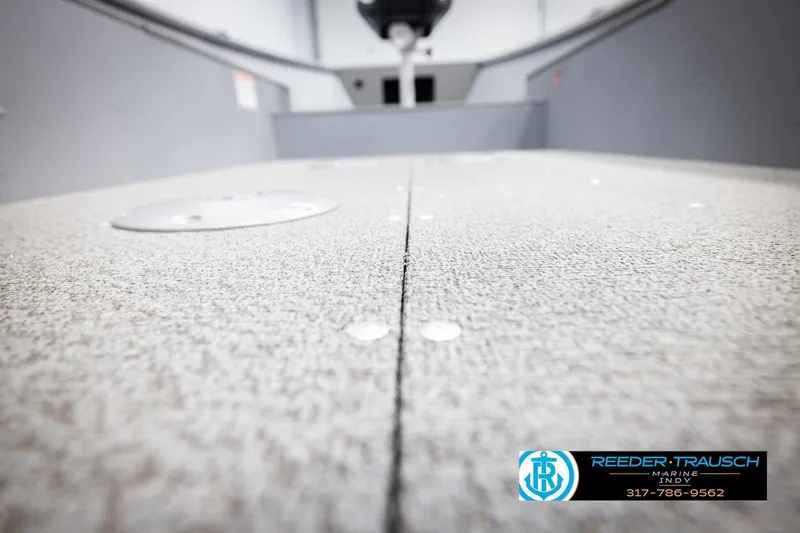 Slide: The Image of 2026 Lund 1600 Fury Tiller boat interior with textured flooring, Reeder-Trausch Marine logo. - 31