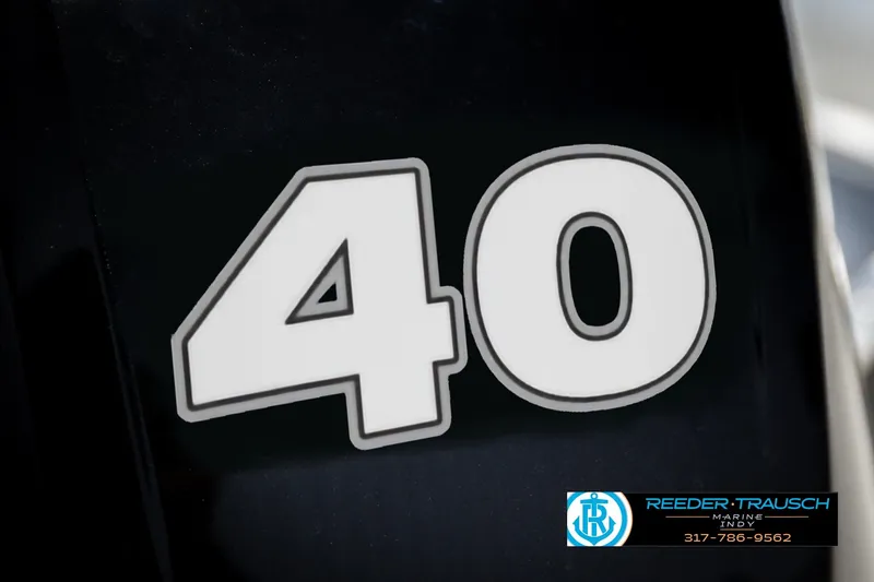Slide: The Image of Close-up of '40' decal on 2026 Lund 1600 Fury Tiller boat, Reeder Trausch Marine logo visible. - 34
