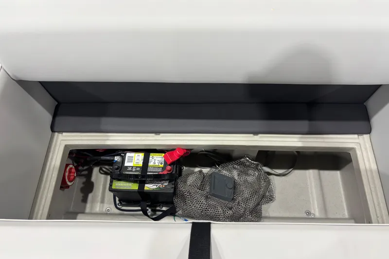 Slide: The Image of 2026 Harris Cruiser 210 storage compartment with battery and accessories. - 10