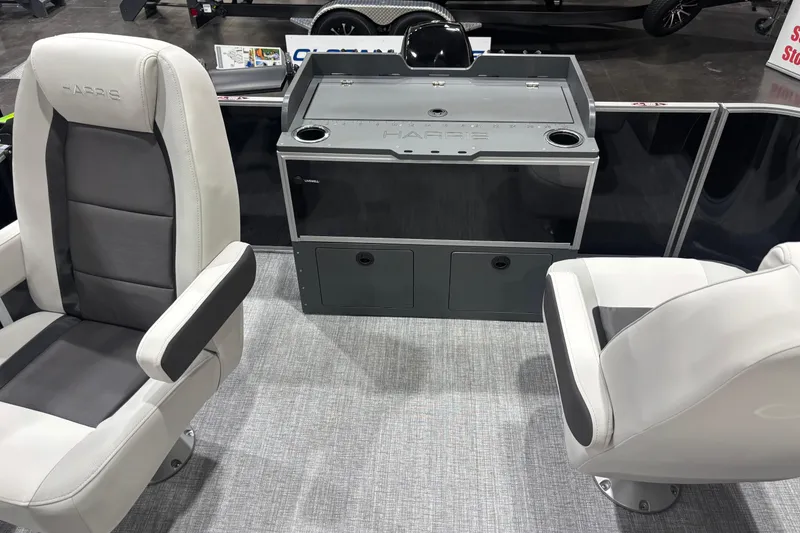 Slide: The Image of 2026 Harris Cruiser 210 boat interior with modern seating and control console. - 11