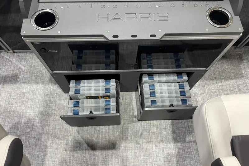 Slide: The Image of 2026 Harris Cruiser 210 boat storage with tackle boxes and cup holders. - 13