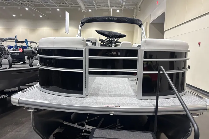 Slide: The Image of 2026 Harris Cruiser 210 pontoon boat displayed indoors, showcasing sleek design and modern features. - 6