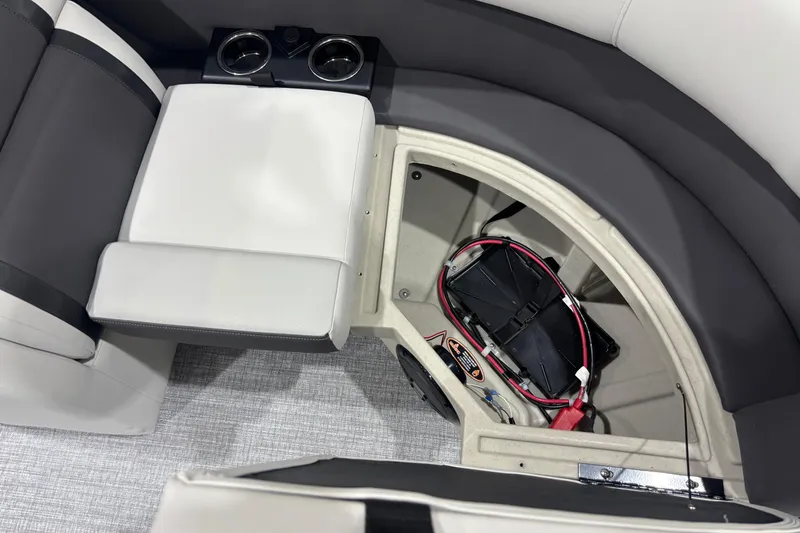Slide: The Image of 2026 Harris Cruiser 210 boat interior with storage compartment and cup holders. - 8