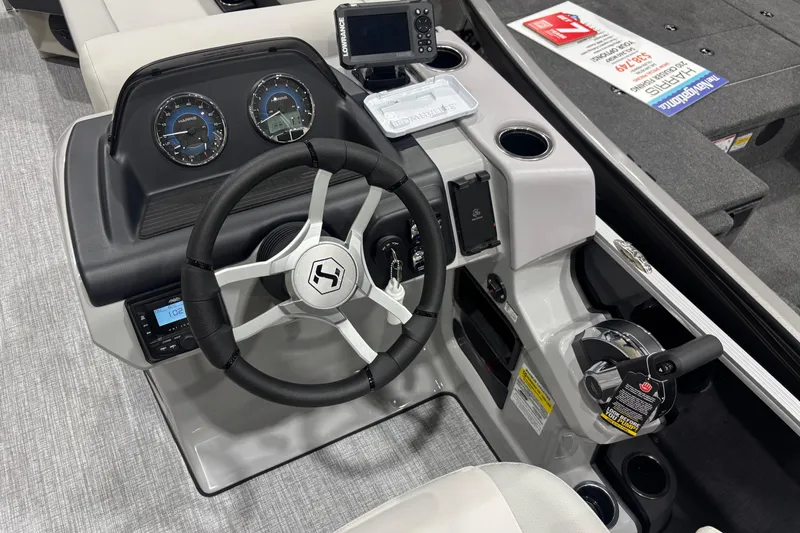 Slide: The Image of 2026 Harris Cruiser 210 boat dashboard with steering wheel and control panel. - 9