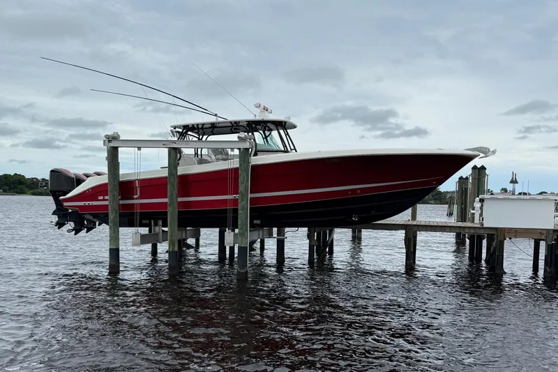 The Image of 2013 Hydra-Sports 42 boat docked on a lift over water. - 0