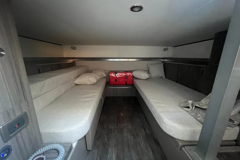Slide: The Image of 2025 Sea Ray Sundancer 320 Coupe cabin interior with twin beds and modern design. - 11