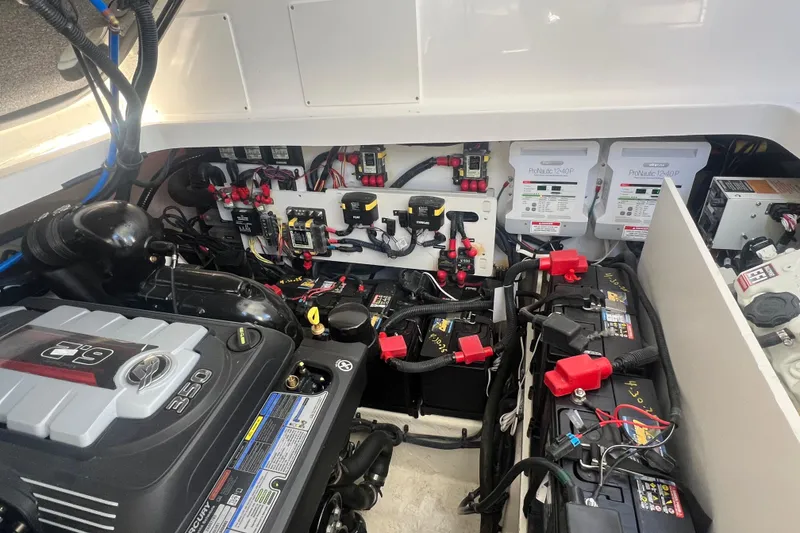 Slide: The Image of Engine compartment of 2025 Sea Ray Sundancer 320 Coupe with batteries and wiring. - 15