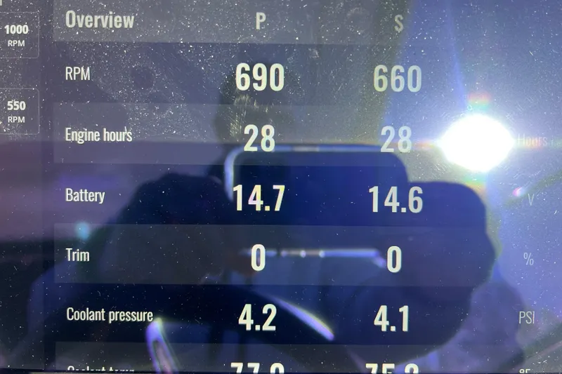 Slide: The Image of Display panel of 2025 Sea Ray Sundancer 320 Coupe showing engine metrics and battery voltage. - 18