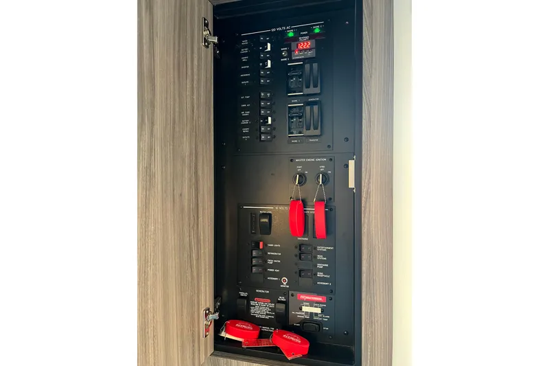 Slide: The Image of Electrical panel inside 2025 Sea Ray Sundancer 320 Coupe yacht, featuring switches and controls. - 8
