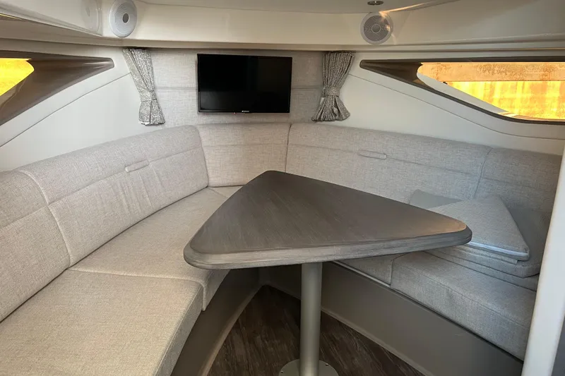 Slide: The Image of 2025 Sea Ray Sundancer 320 Coupe interior with cozy seating and modern amenities. - 9
