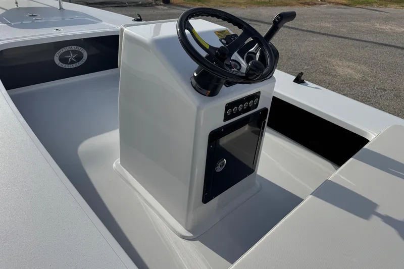 Slide: The Image of 2026 Chittum Skiffs 18 Laguna Madre boat console with steering wheel and controls. - 10
