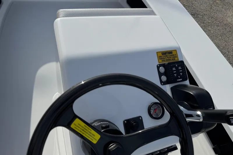 Slide: The Image of Steering console of 2026 Chittum Skiffs 18 Laguna Madre boat, featuring controls and gauges. - 11