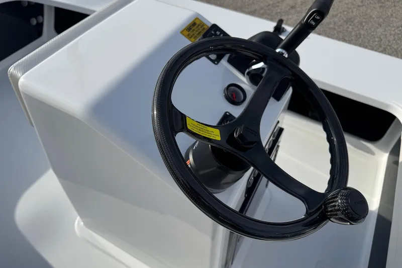 Slide: The Image of Steering console of 2026 Chittum Skiffs 18 Laguna Madre boat, featuring sleek design. - 12