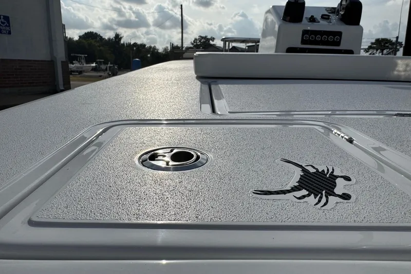 Slide: The Image of 2026 Chittum Skiffs 18 Laguna Madre boat deck with textured surface and scorpion logo. - 16