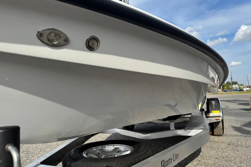 Slide: The Image of 2026 Chittum Skiffs 18 Laguna Madre boat on trailer, close-up view. - 19