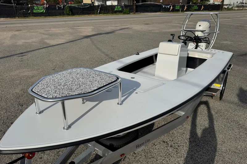 Slide: The Image of 2026 Chittum Skiffs 18 Laguna Madre boat on trailer, parked on pavement. - 3