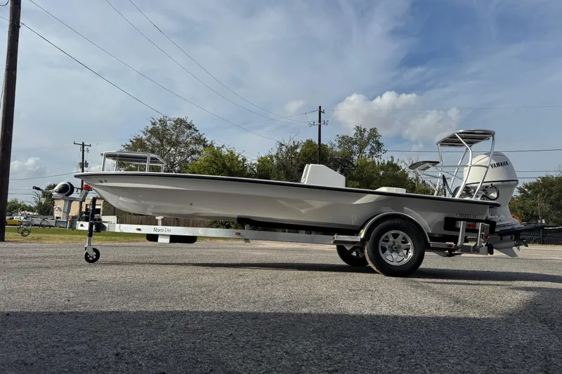 Slide: The Image of 2026 Chittum Skiffs 18 Laguna Madre boat on trailer, parked outdoors. - 5