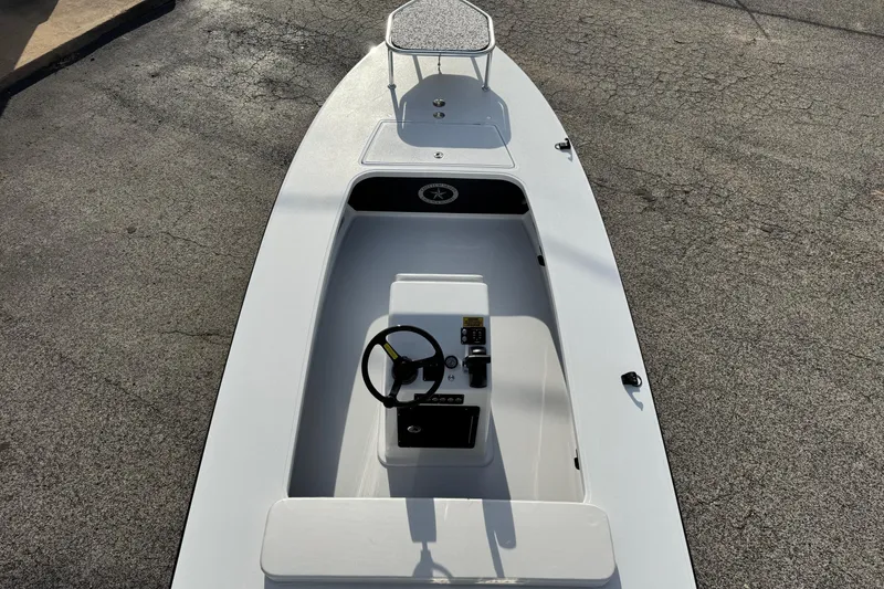Slide: The Image of 2026 Chittum Skiffs 18 Laguna Madre boat, top view, showcasing sleek design and steering console. - 6