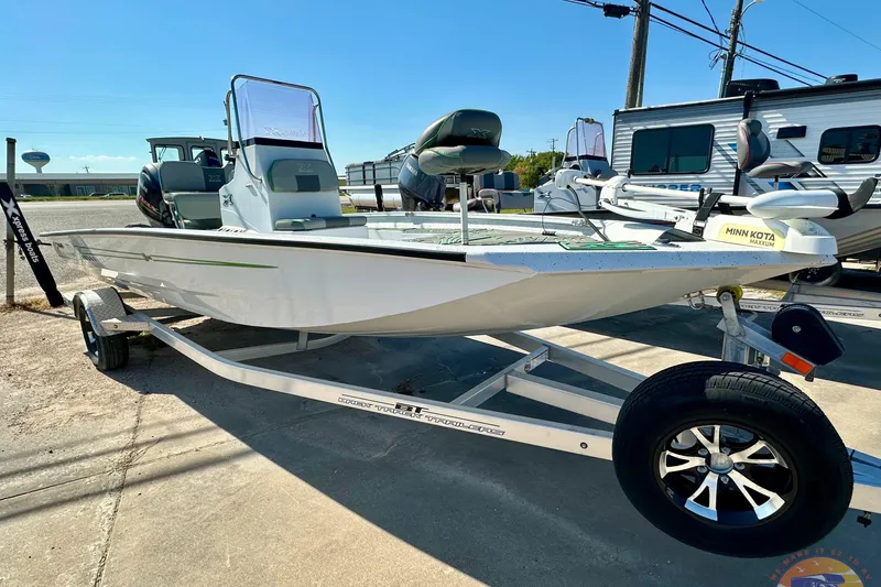 The Image of 2024 Xpress H20B Bay boat on trailer, featuring Minn Kota trolling motor. - 1