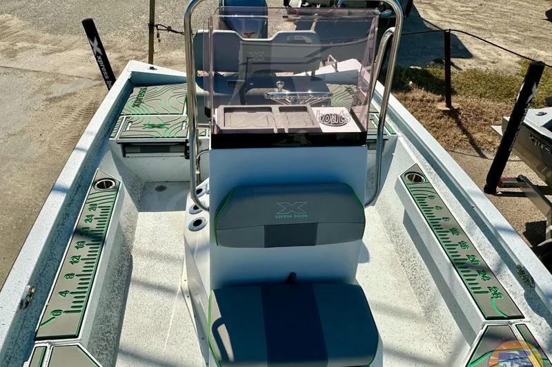 Slide: The Image of 2024 Xpress H20B Bay boat interior with console and measuring graphics. - 13