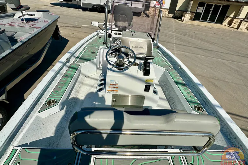 Slide: The Image of 2024 Xpress H20B Bay boat interior with steering console and seating. - 14