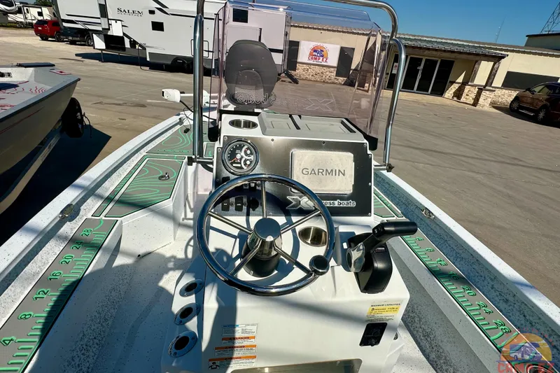 Slide: The Image of 2024 Xpress H20B Bay boat dashboard with Garmin navigation system and steering wheel. - 15
