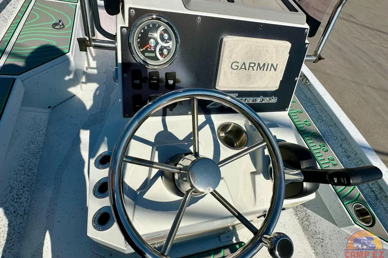 Slide: The Image of 2024 Xpress H20B Bay boat dashboard with Garmin navigation and steering wheel. - 16