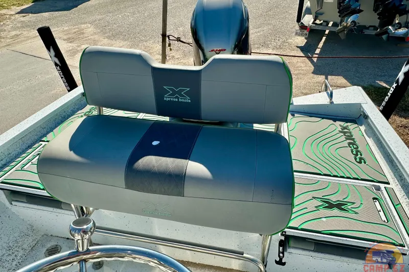 Slide: The Image of 2024 Xpress H20B Bay boat interior with cushioned seating and branded flooring. - 18