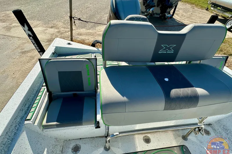 Slide: The Image of 2024 Xpress H20B Bay boat seating area with gray and green upholstery. - 20