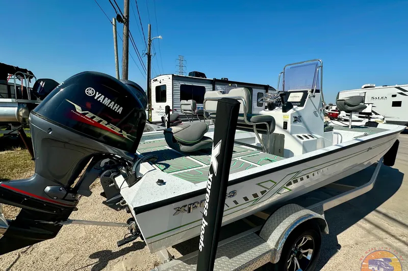 Slide: The Image of 2024 Xpress H20B Bay boat with Yamaha engine, parked on a trailer. - 5