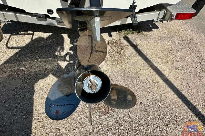 Slide: The Image of 2024 Xpress H20B Bay boat propeller on gravel surface, rear view. - 8