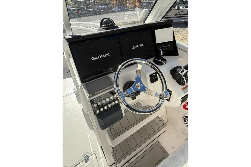 Slide: The Image of 2025 Sea Fox 288 Traveler helm with Garmin displays and modern steering wheel. - 11
