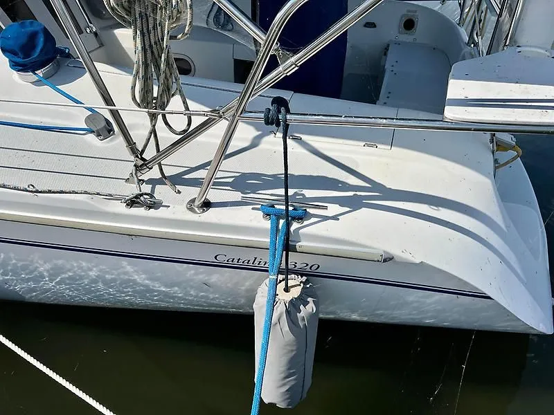 Slide: The Image of Catalina 320 sailboat from 2000, docked with fender and ropes visible. - 12