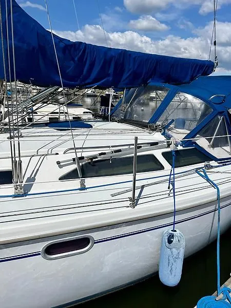 Slide: The Image of Catalina 320 sailboat, 2000 model, docked with blue sail cover and clear skies. - 13