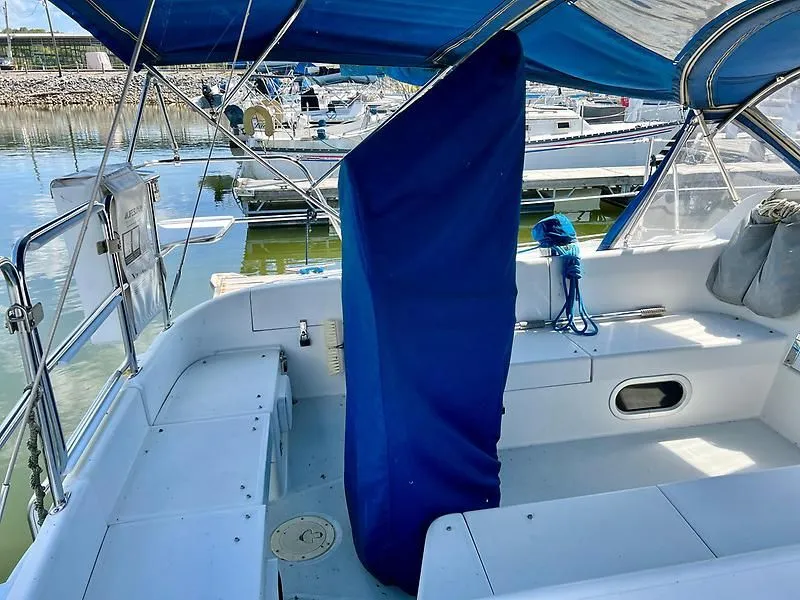 Slide: The Image of Cockpit of 2000 Catalina 320 sailboat with blue cover, docked at marina. - 18