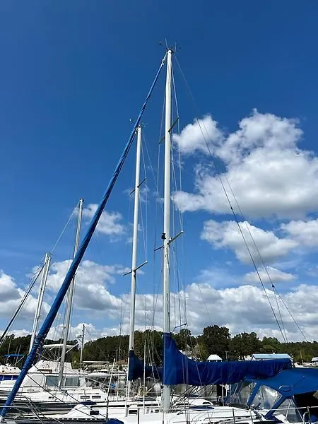 Slide: The Image of Sailboat with tall masts under blue sky, Catalina 320, year 2000. - 21