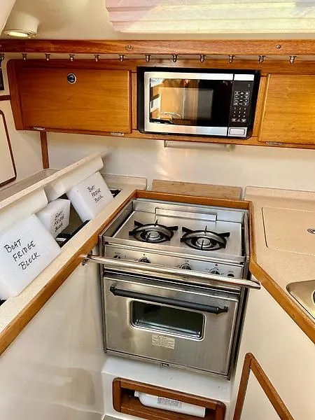 Slide: The Image of Catalina 320 yacht kitchen with stove, microwave, and storage, 2000 model. - 36