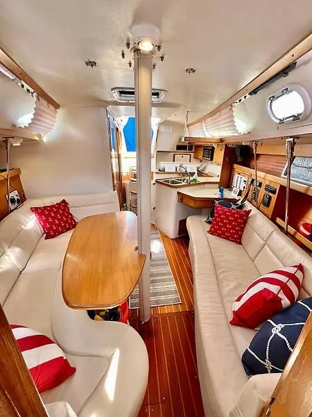 Slide: The Image of Interior of 2000 Catalina 320 sailboat with cozy seating and nautical decor. - 45