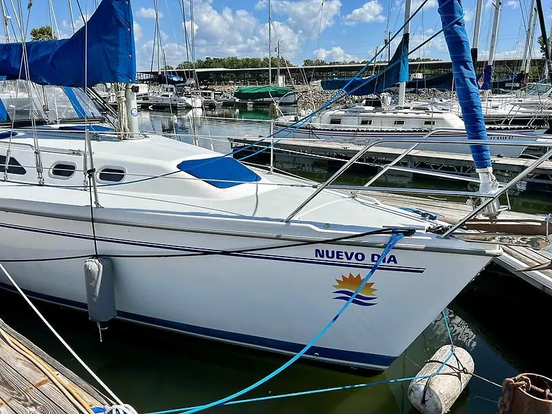 Slide: The Image of Catalina 320 sailboat named "Nuevo Dia" docked at marina, sunny day, 2000 model. - 7