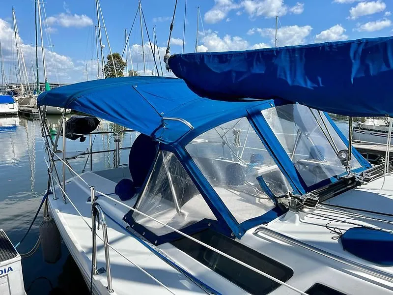 Slide: The Image of Catalina 320 sailboat, 2000 model, with blue canopy docked at marina. - 8