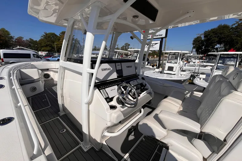 Slide: The Image of 2019 Fountain 38 Center Console boat interior with Simrad electronics and luxurious seating. - 16