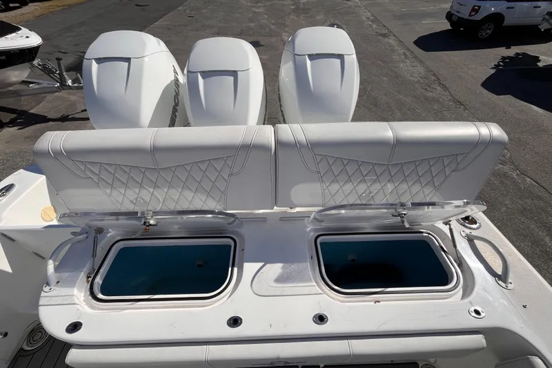 Slide: The Image of 2019 Fountain 38 Center Console boat with triple outboard engines and open storage compartments. - 19