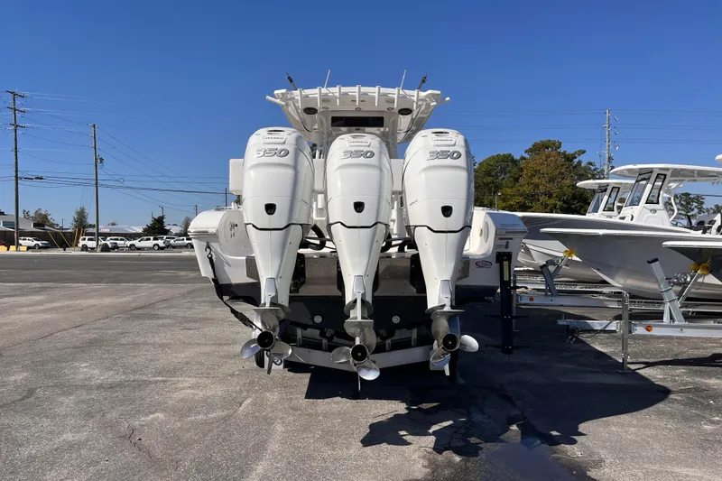 Slide: The Image of 2019 Fountain 38 Center Console with triple 350 horsepower engines, parked outdoors. - 3