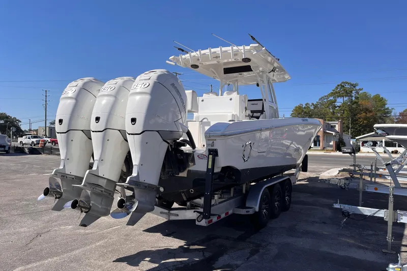 Slide: The Image of 2019 Fountain 38 Center Console boat with triple Mercury 350 engines on a trailer. - 4