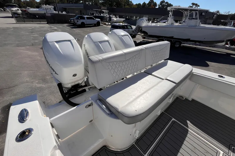 Slide: The Image of 2019 Fountain 38 Center Console boat with triple Mercury outboard engines and cushioned seating. - 5