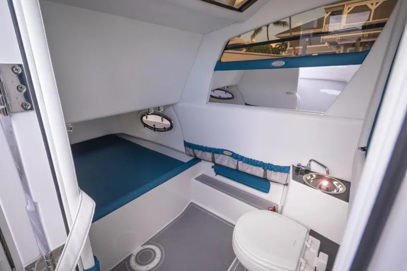 Slide: The Image of Manufacturer Provided Image: Interior of 2025 Nor-Tech 340 Sport Center Console boat, featuring a compact cabin. - 16