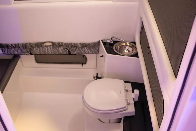 Slide: The Image of Manufacturer Provided Image: 2025 Nor-Tech 340 Sport Center Console interior with toilet and sink. - 17