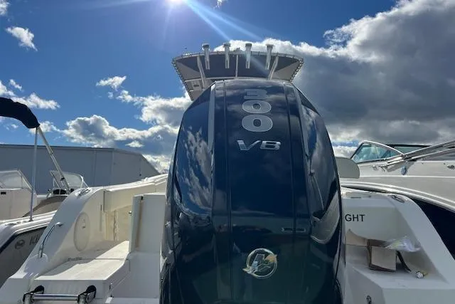 Slide: The Image of 2020 Cobia 237 Center Console boat with powerful 300 V8 engine under sunny sky. - 6