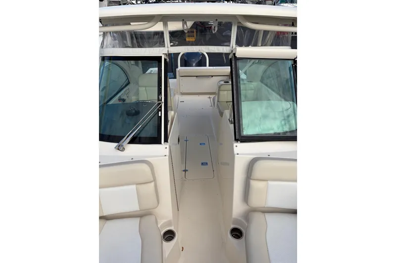 Slide: The Image of 2012 Pursuit DC 265 Dual Console boat interior with seating and windshield. - 10